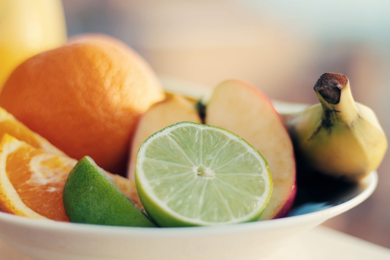 services-05 A close-up of a fresh mixed fruit bowl featuring citrus, banana, and apple slices for a healthy snack.